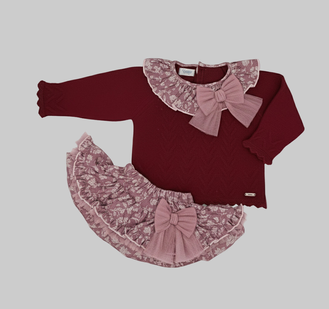 Red sweater with lace collar and pink ruffled skirt on a white background, brand 'Rahigo' visible.